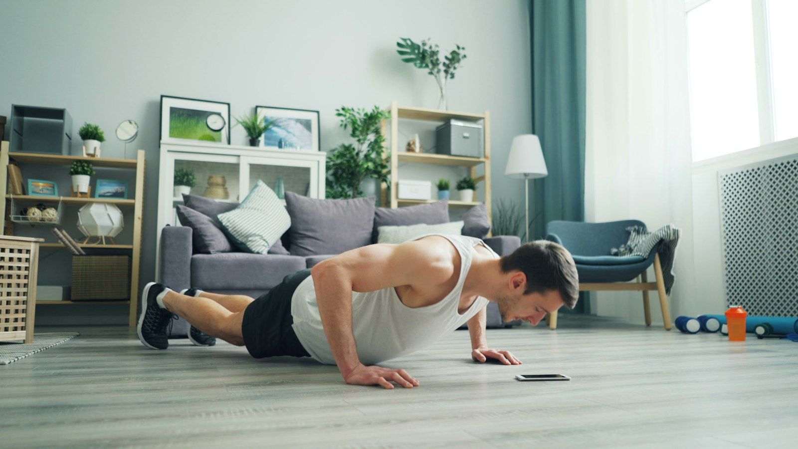 Hombre haciendo flexiones en el salón de su casa
